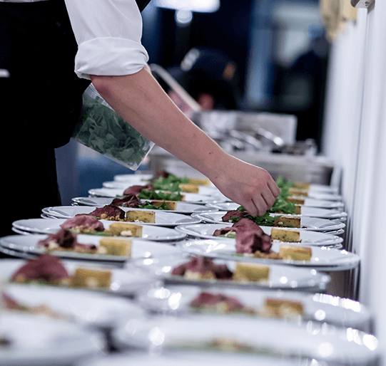 chef-garnishing-food Chef garnishing several plates of food